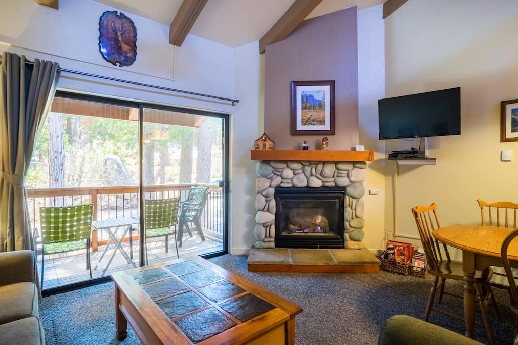 View of the living area with fireplace and balcony.