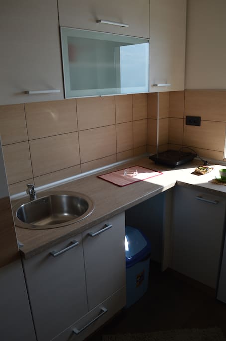 Kitchen, including stove and fridge.