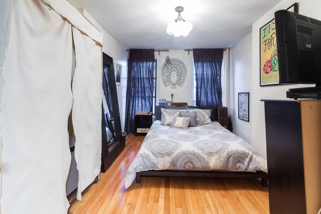 Spacious bedroom with queen size bed, plenty of storage and flatscreen TV w/ HD Channels