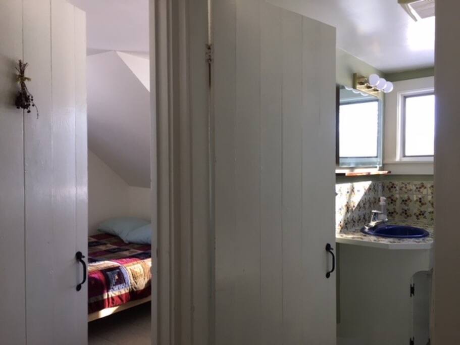 Upstairs hallway showing door to bedroom and door to bathroom.