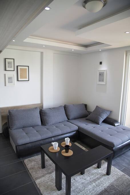 A small but useful coffee table placed on a soft, warm, thick carpet. The lowered ceiling design with hidden and spot led lights for cool evening setting.