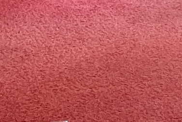 The image features a textured surface in a warm reddish hue. The pattern displays a subtle, uniform design that can add a sense of warmth and comfort to the surrounding environment.