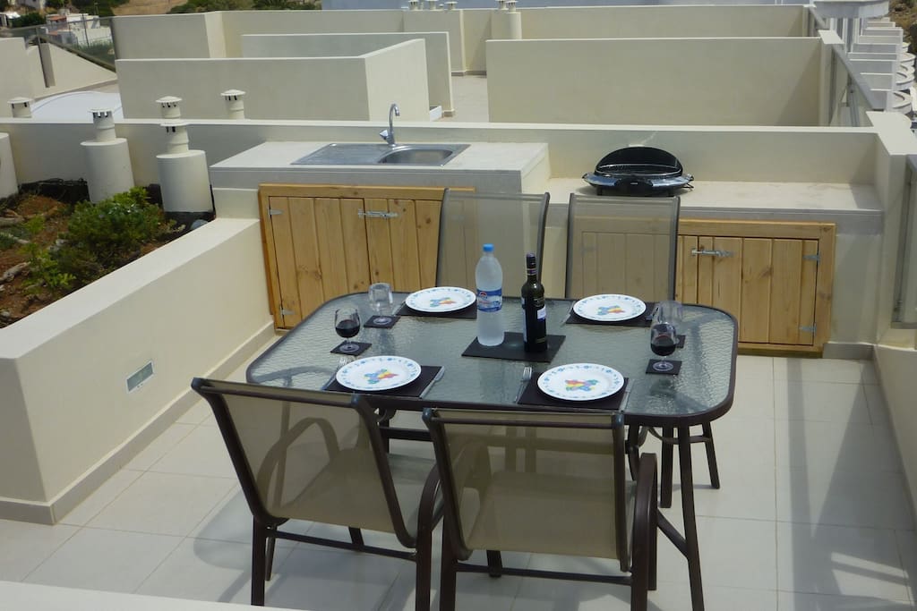 Dining area on private roof terrace, including refrigerator in cupboard