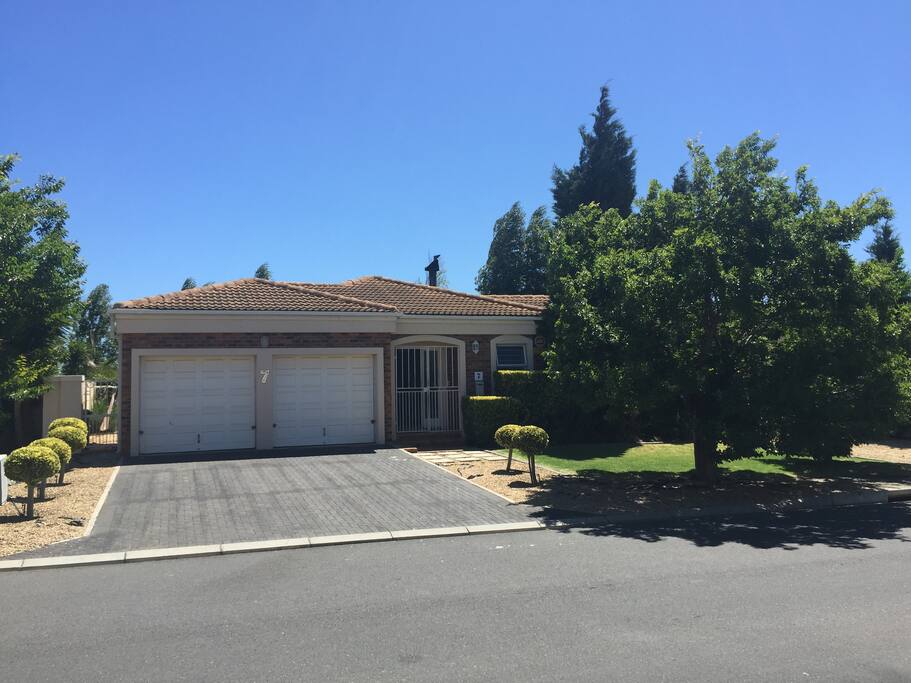 A beautiful family home with manicured leafy gardens in a quiet cul de sac.