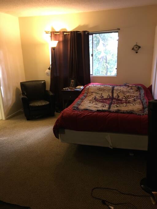 Private bedroom with Queen sized bed, tv and private full bathroom with shower and toilet.
