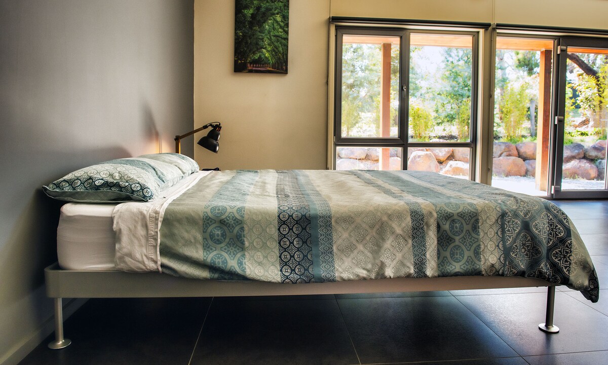 Queen bed set up in the Studio Living Room. This bed is only set up when required. Otherwise the space is handy for table tennis.