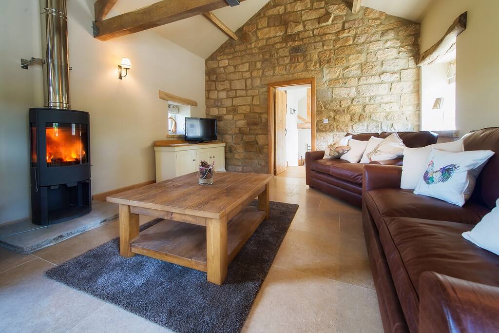 Large beamed space is tastefully decorated in greys with a dining table seating 4 guests, luxurious leather seating and a contemporary log burner (Please note this becomes hot so children must be supervised)