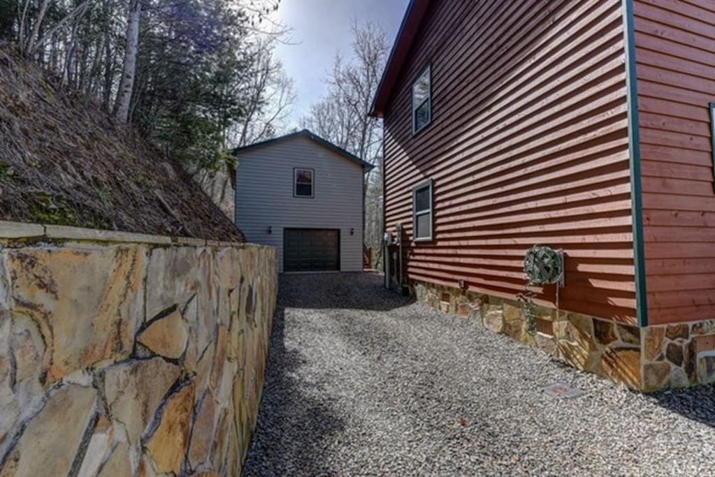 Room is on second floor above the garage, stairs are on the right side of the garage. You can either park in the front of the main house or to the right of the garage.