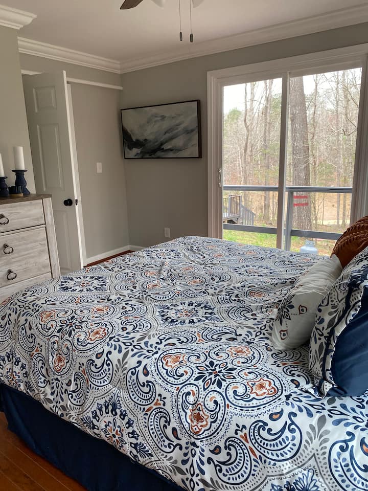 Main bedroom with lake view and deck access