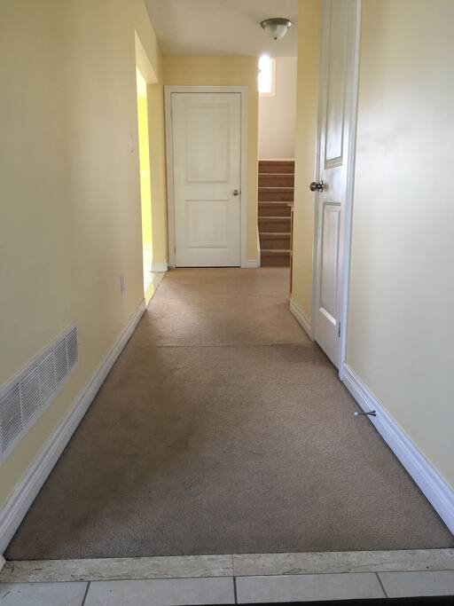 The mainfloor hallway. Door on the right is a powder room in case you need to check your hair in the mirror before heading out.