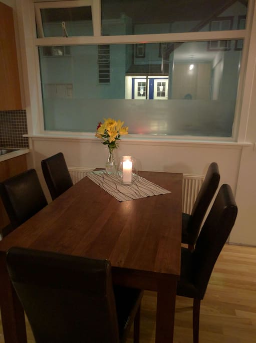Dining table, there are 6 matching chairs. Wooden curtains missing here