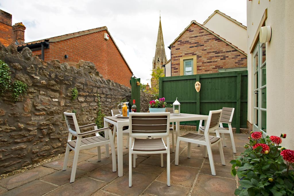 Spacious private patio, perfect for al fresco drinks, sunny breakfasts, BBQs (large BBQ provided), gate to garage area.