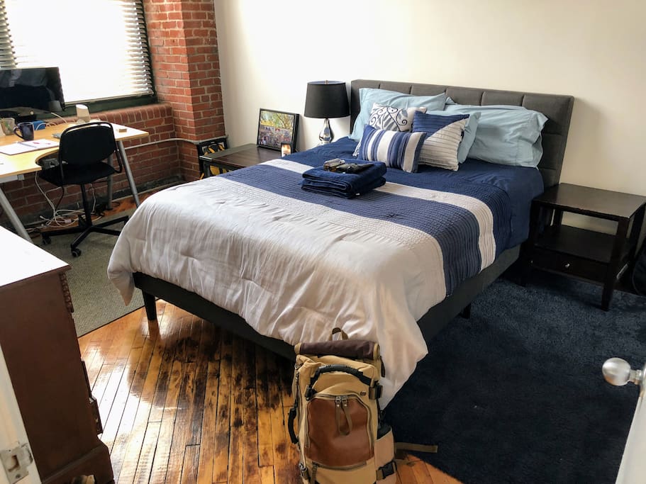 Queen size memory foam mattress with bedside tables, a TV, Xbox, desk and monitor (in case you have to get some work done)