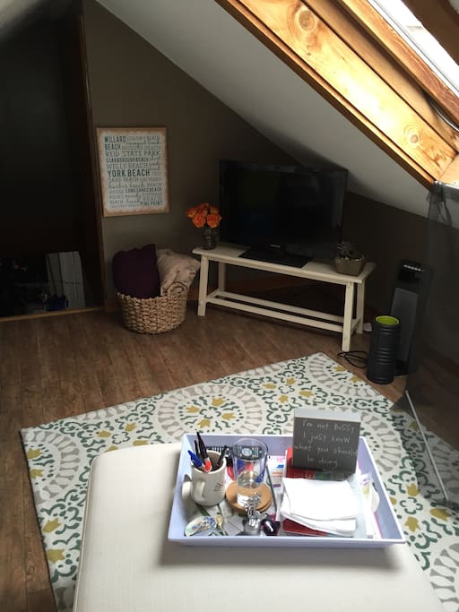 Well lit loft with light from a skylight that you can pop your head out and check out the view of the entire city. The TV is connected to a Roku with Hulu, Netflix and Amazon Prime. Wifi is free and available too!