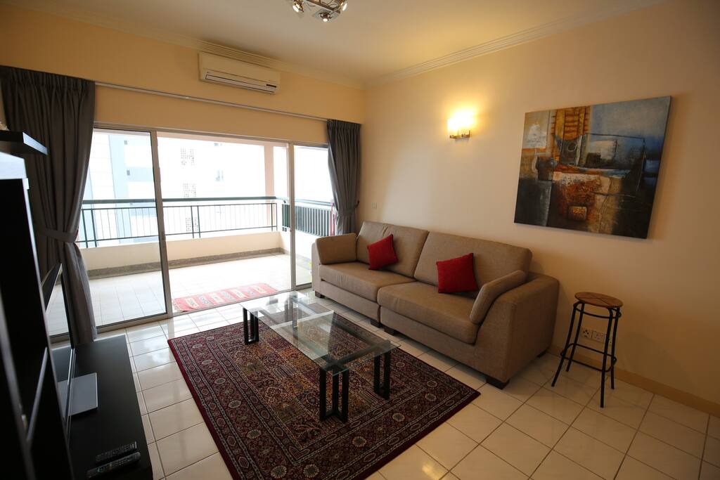 Spacious and comfortable living space with scenic balcony view.