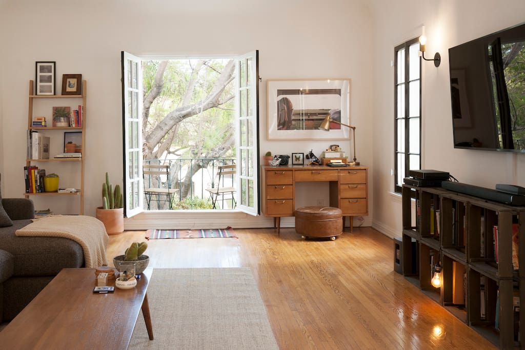 Open the doors to a beautiful breeze and outdoor balcony overlooking the street