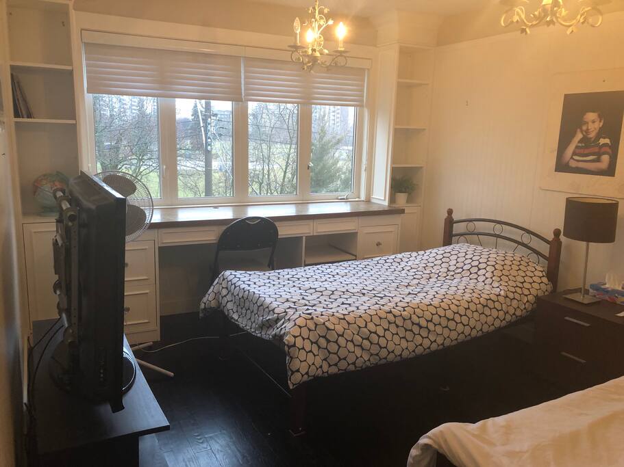Guest airbnb room two beds tv