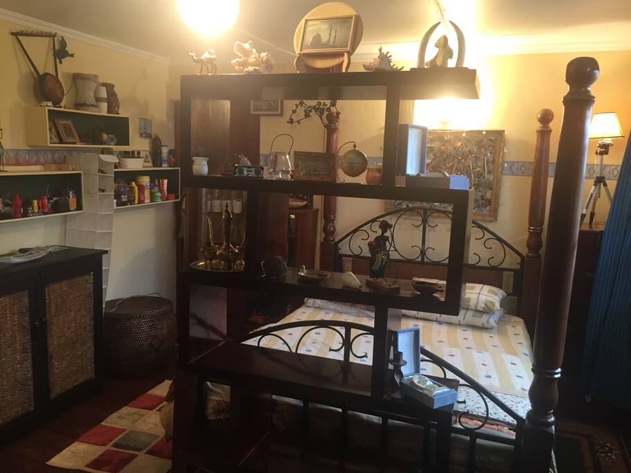 Bed and shelf together with many collected items from my own travelling