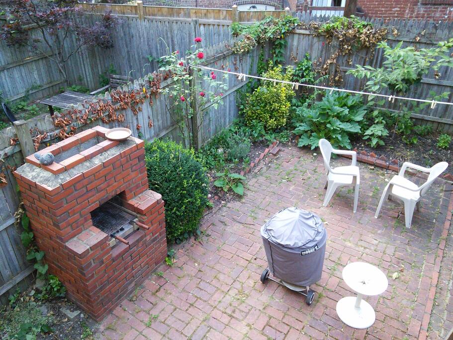 Back yard both brick and coal fire grills and seating area