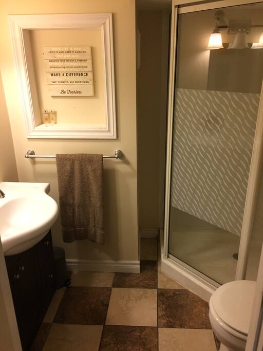 Private bathroom with toilet, vanity and shower