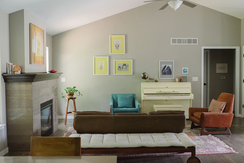 Our open space living room with piano and fireplace.