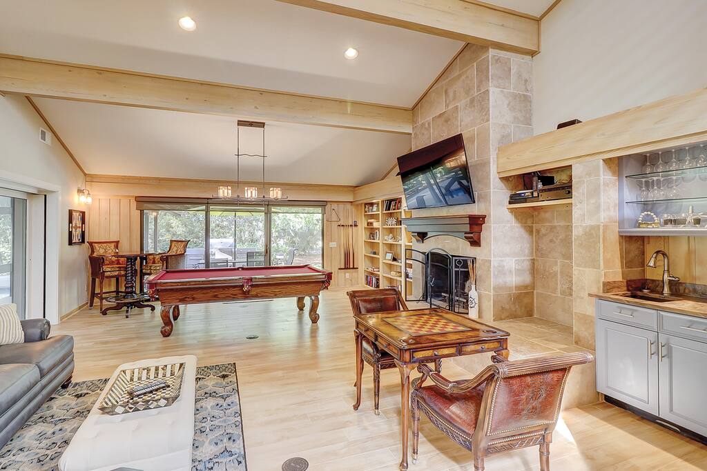 The game lounge is boasts billiards, a card table, chess, and book-filled shelves.