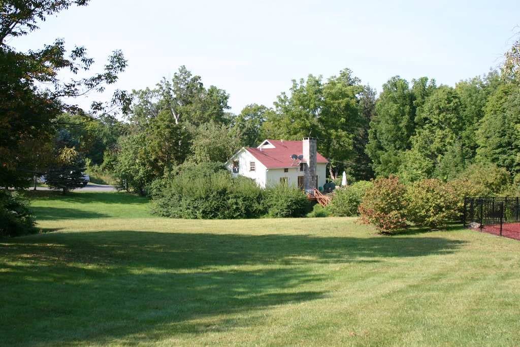 Cottage surrounded by 10 acres of lush lawn, trees and nature