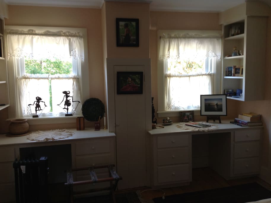 The guest room with windows looking over yard.