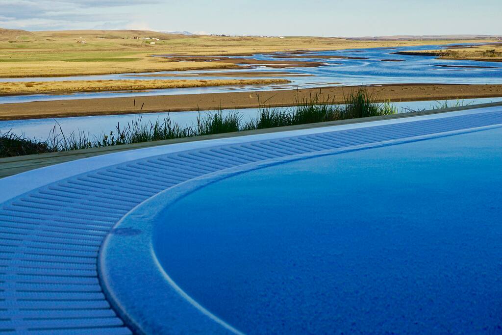 Amazing View from the Hot Tub over the river Hvítá, mountain view over the active volcanos Eyjafjallajökull and Hekla