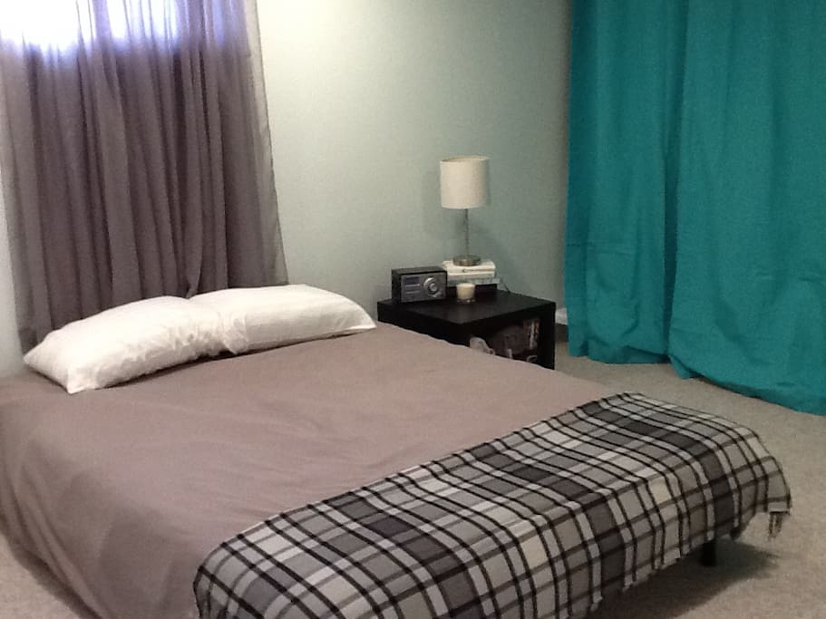 Bedroom 1, the Poolside Room, is a large room with a queen bed and a bonus loft with two twin mattresses, curtained off for privacy. Sleeps 4 guests.