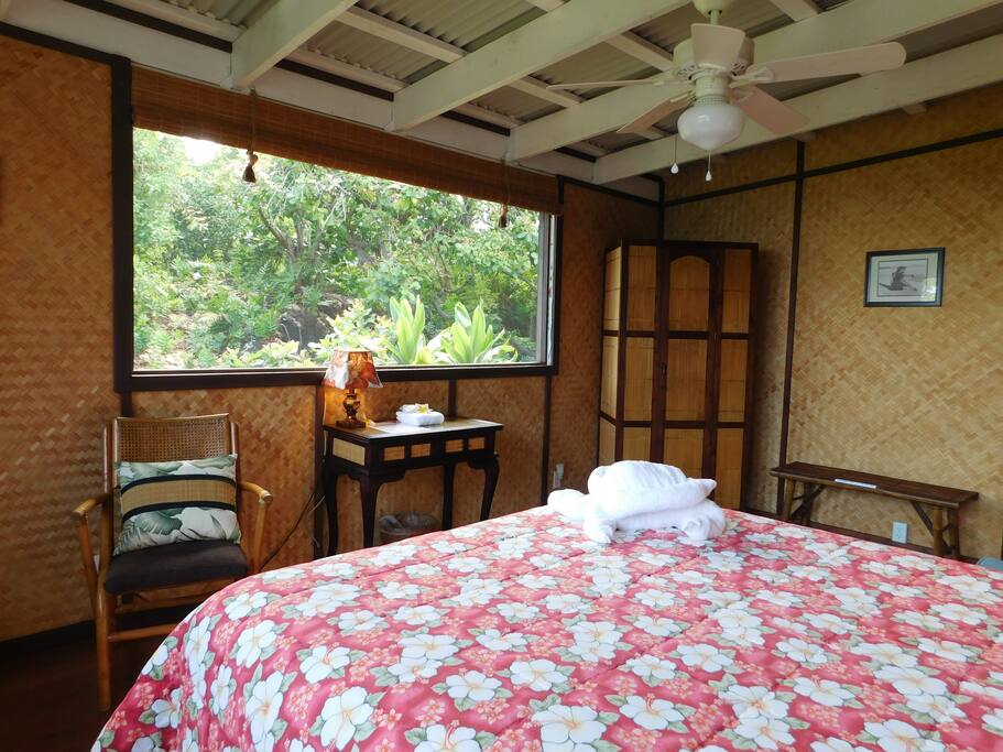 One large screened window provides fresh air and a lush garden view.