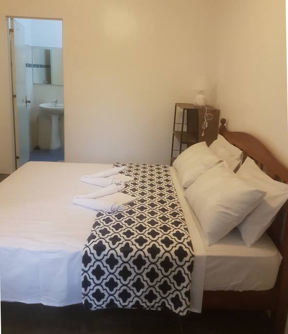 bedroom with ensuite bathroom and A/C