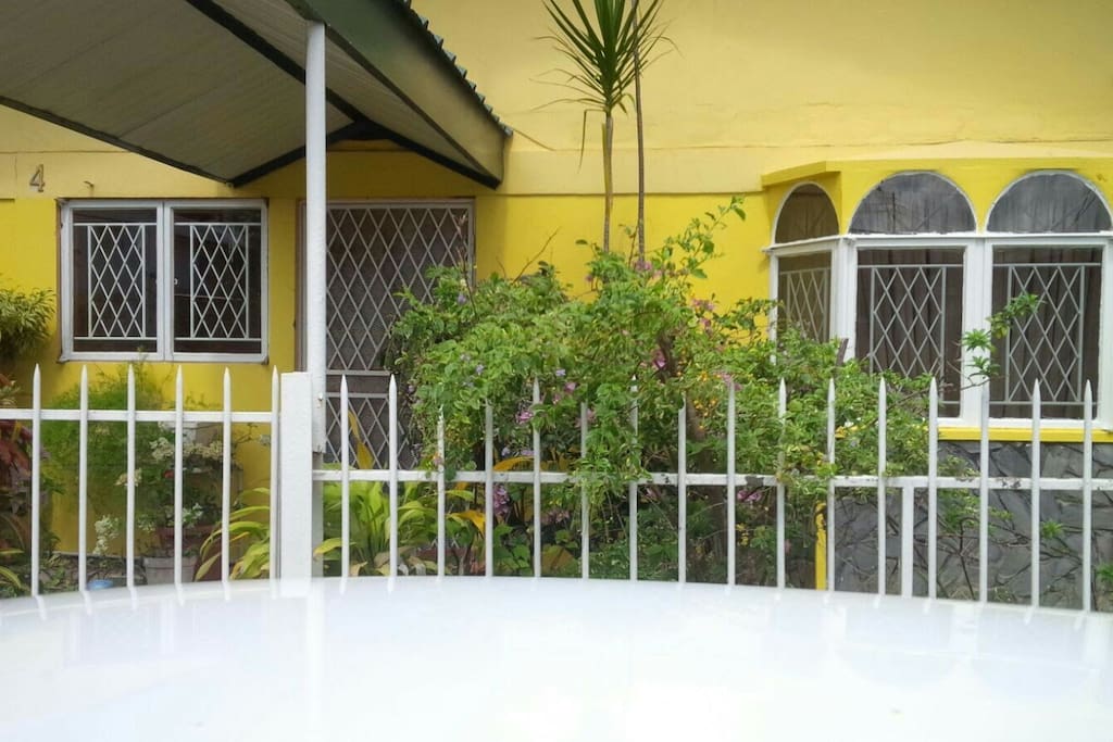 Covered entrance to property; guests can lounge outdoors amongst the greenery