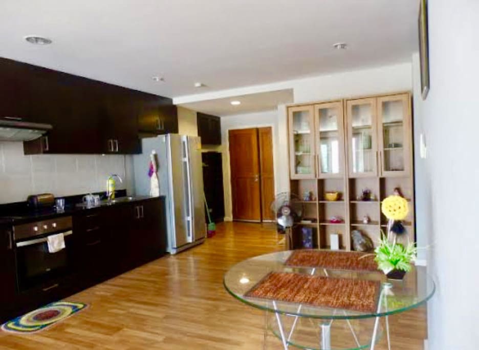 Modern kitchen with oven and big size two door refrigerator.