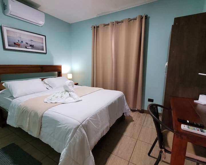 Main room with Queen bed, AC, desk and 40" smart TV