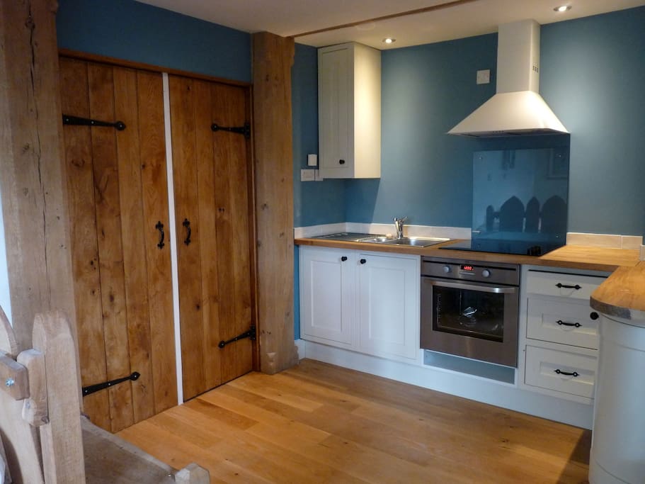 The fully equipped kitchen with large cupboards for coats & wellies etc.