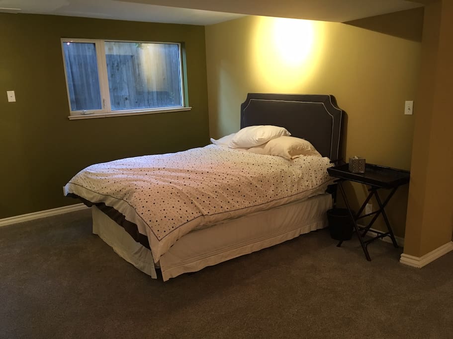 Queen bed in a large bedroom