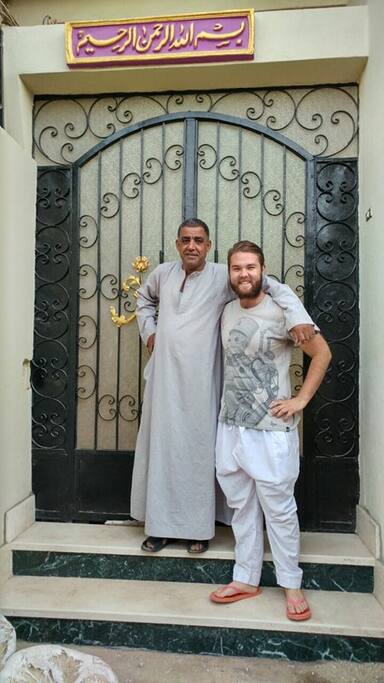 Ismael with a guest at the front door