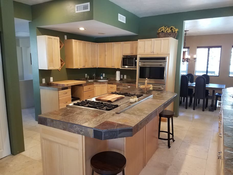 Gourmet kitchen with double ovens, large cook top, dishwasher.