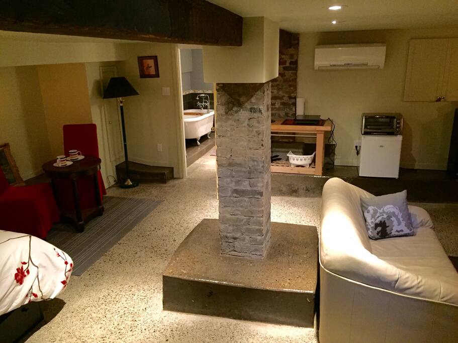 Exposed brick and beams, polished concrete floor, kitchenette, and a clawfoot tub. Come stay in our awesome Bachelor Suite in Toronto's famous Distillery District.