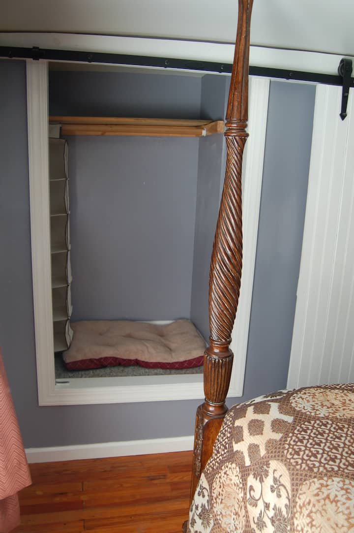Bedroom spot for your pet as well as a large barn door covered closet for your clothes on the other side