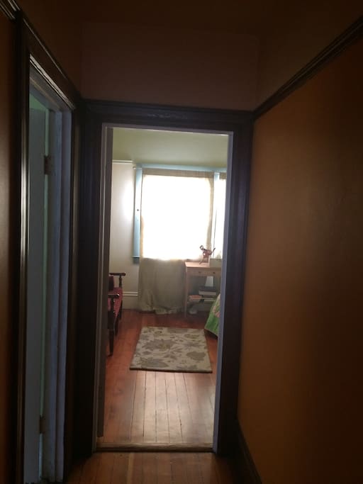 Doorway into the room (bathroom on the left).