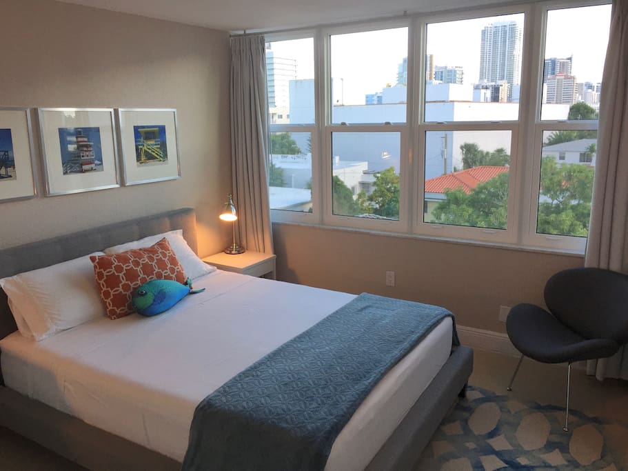 Your bedroom, with floor-to-ceiling drapes, brand new windows and a great open view.