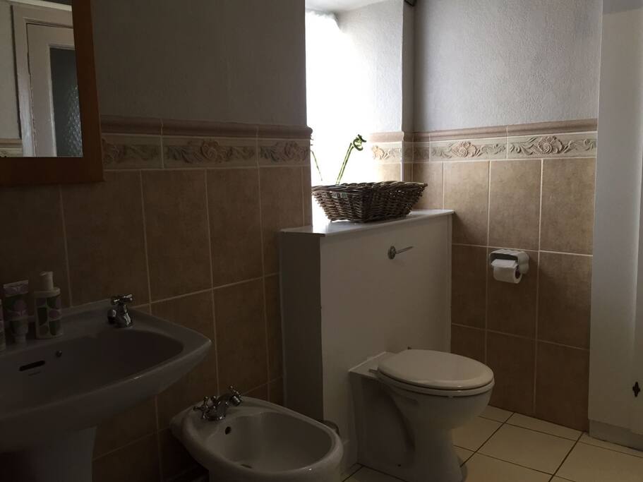 Bathroom with bath and electric shower
