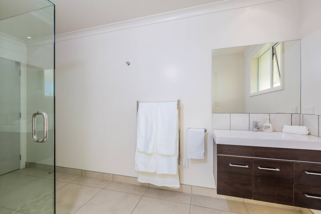 A large tiled ensuite bathroom.