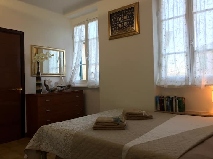 Bedroom, windows with sea view.
Left of the Mirror you can see the door to the bathroom