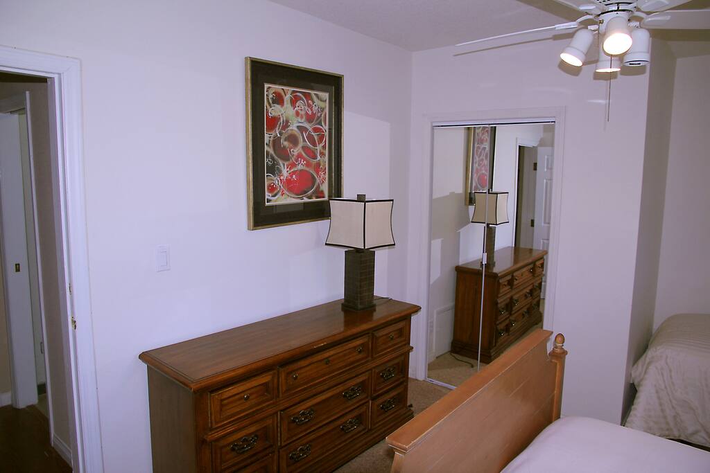 Dresser and mirror doors leading to walk in closet