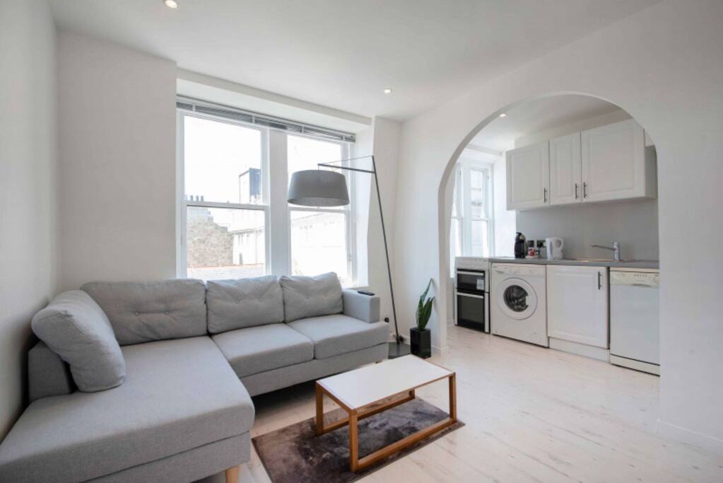 Open plan living room- kitchen. The kitchen equipped with: fridge-freezer, cooker-oven, microwave, washing machine, dishwasher, kettle and a coffee machine.