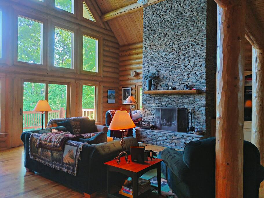 Two story soaring living room with fabulous views, stacked stone fireplace