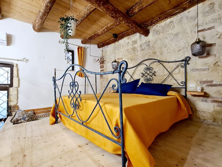 Bedroom on loft with queen size bed and hammock suspended
